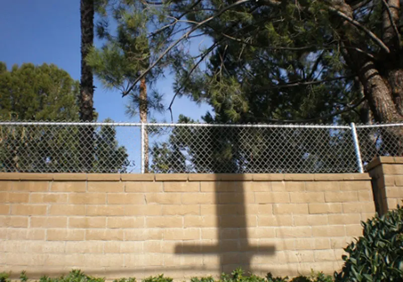 Chain Link Fence Atop Brick Wall