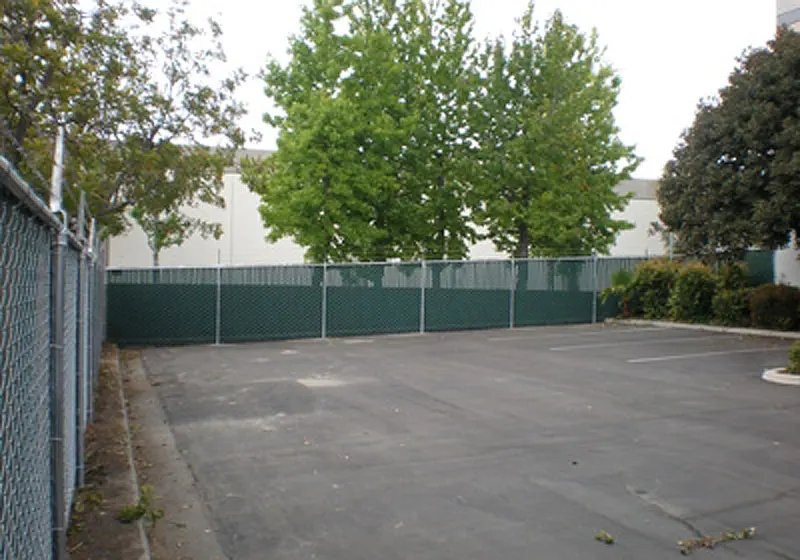 Parking Lot Perimeter Fence W/ Green Slats